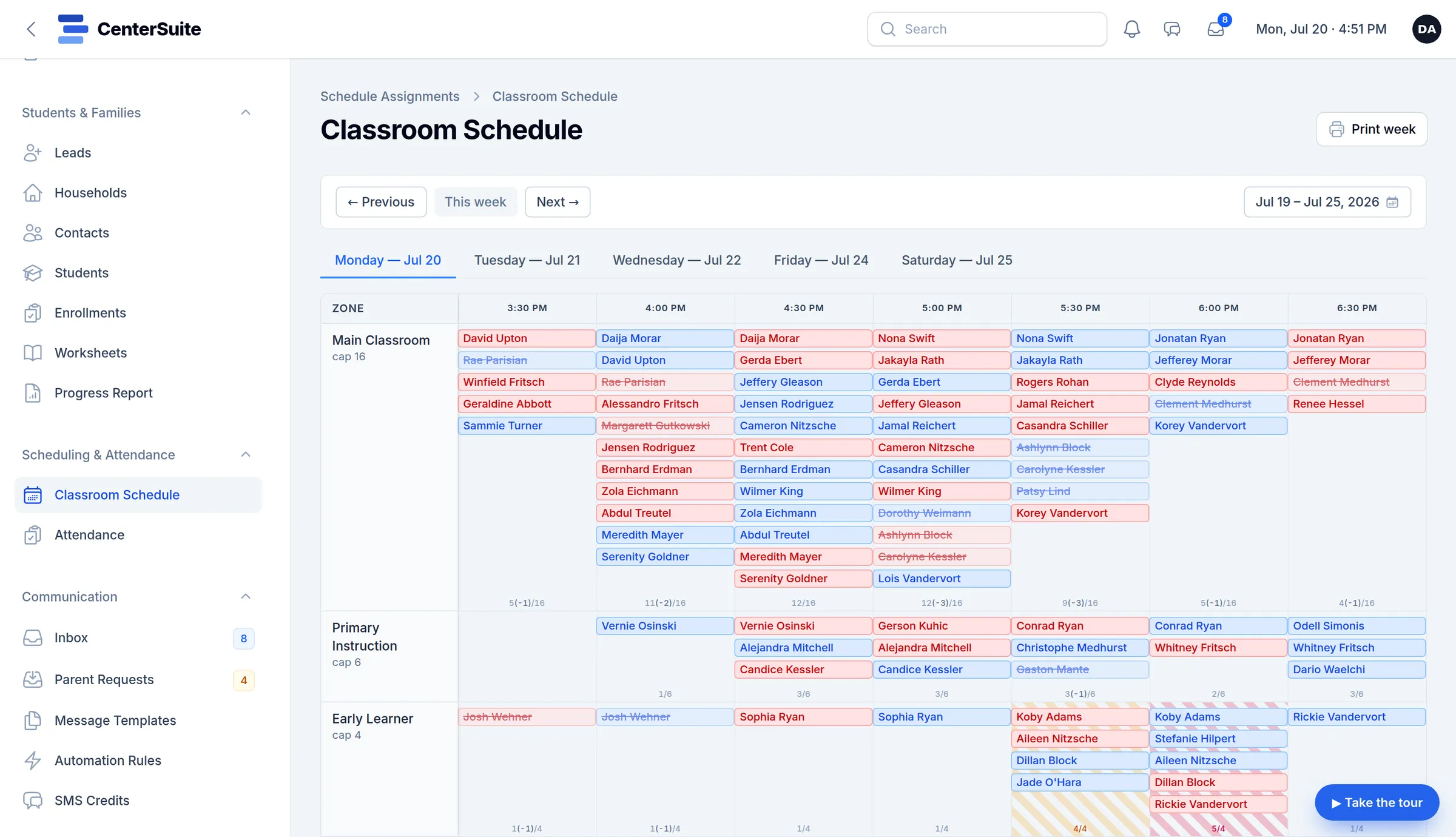 CenterSuite’s weekly classroom schedule, with students listed by room and half-hour slot, color-coded by subject, capacity counts under each slot and absences struck through. The names are demo data.